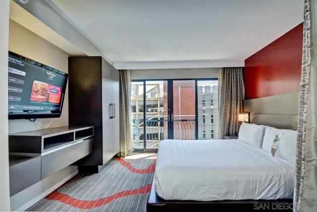 a bedroom with a bed and a flat screen tv