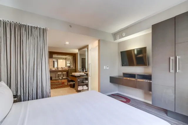 a bedroom with furniture and a large window