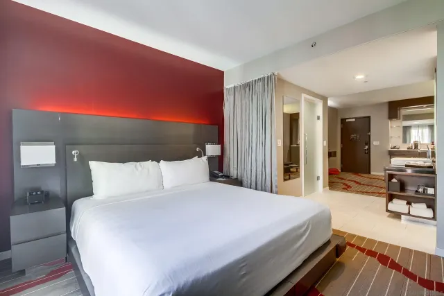 a large bed sitting in a bedroom next to a window