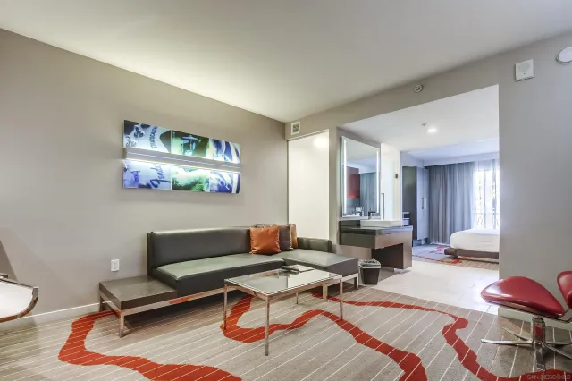 a living room with furniture a rug and a table