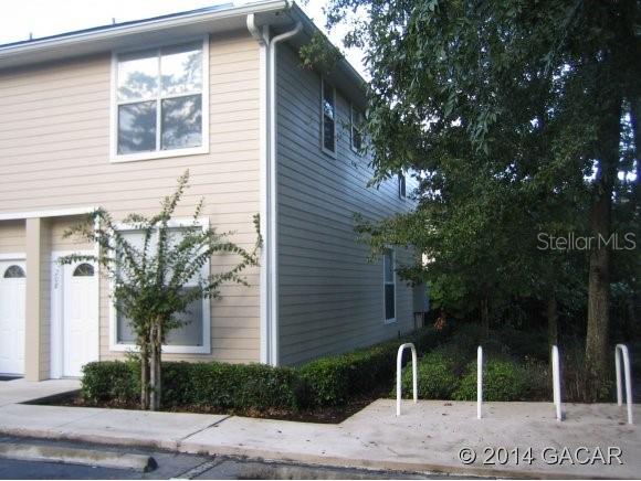 3901 Southwest 20th Avenue, Unit 208 Gainesville, FL 32607 - Photo 1 of 1 a front view of a house with garden