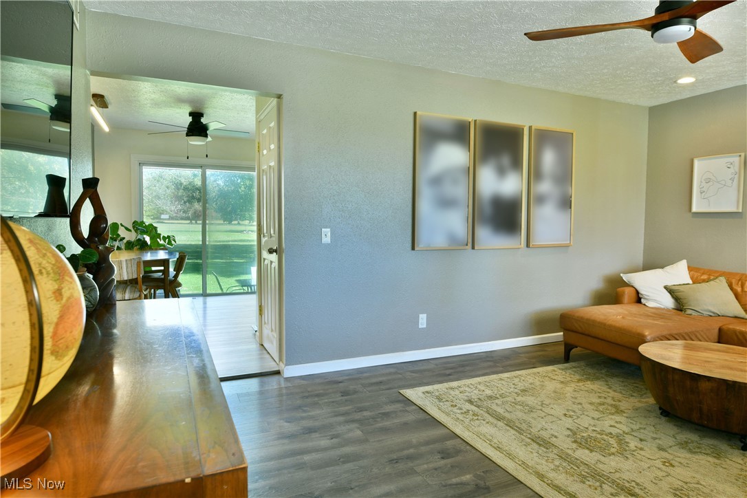 4400 Ridge Road Cortland, OH 44410 - Photo 20 of 50 Living area featuring ceiling fan, a textured ceiling, and dark wood finished floors
