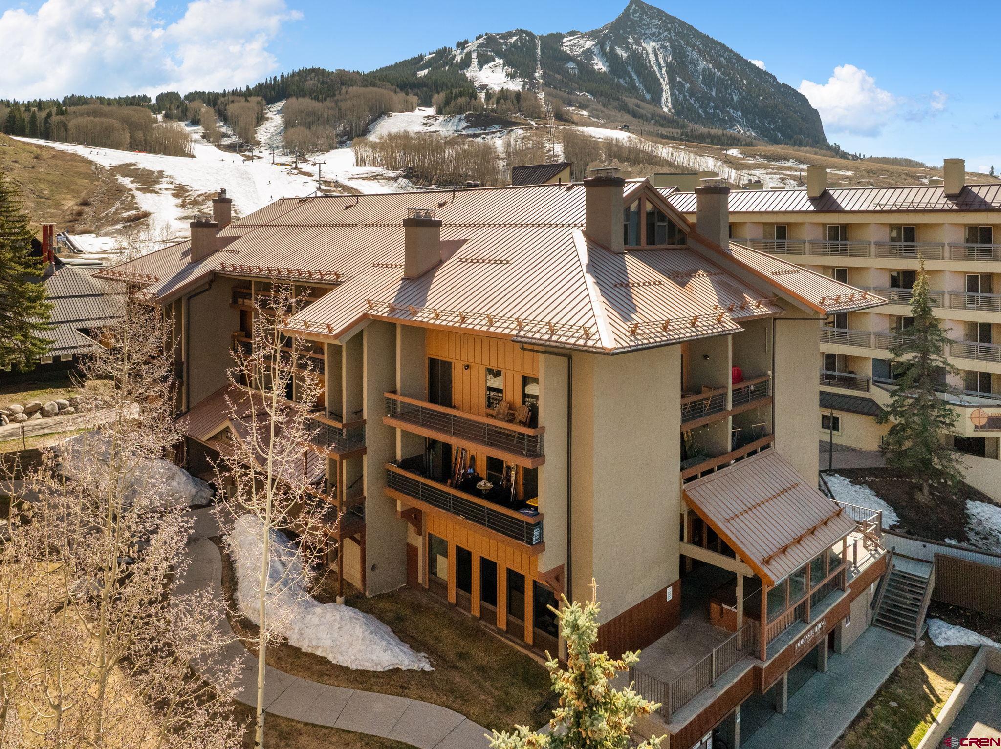 11 Emmons Road, Unit 433 Crested Butte, CO 81225 - Photo 1 of 32 a view of a large building with a yard