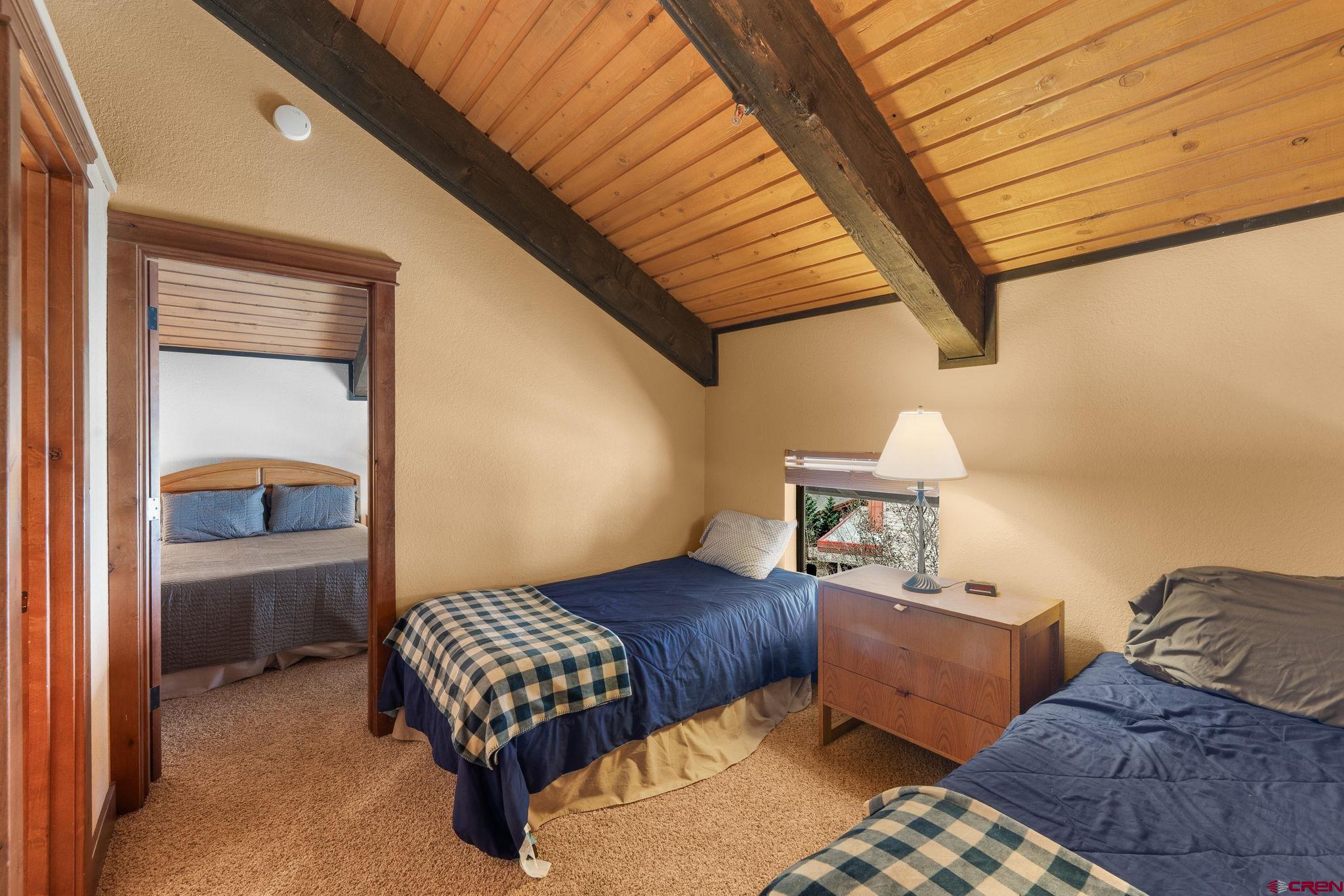 11 Emmons Road, Unit 433 Crested Butte, CO 81225 - Photo 13 of 32 a bedroom with furniture and a window