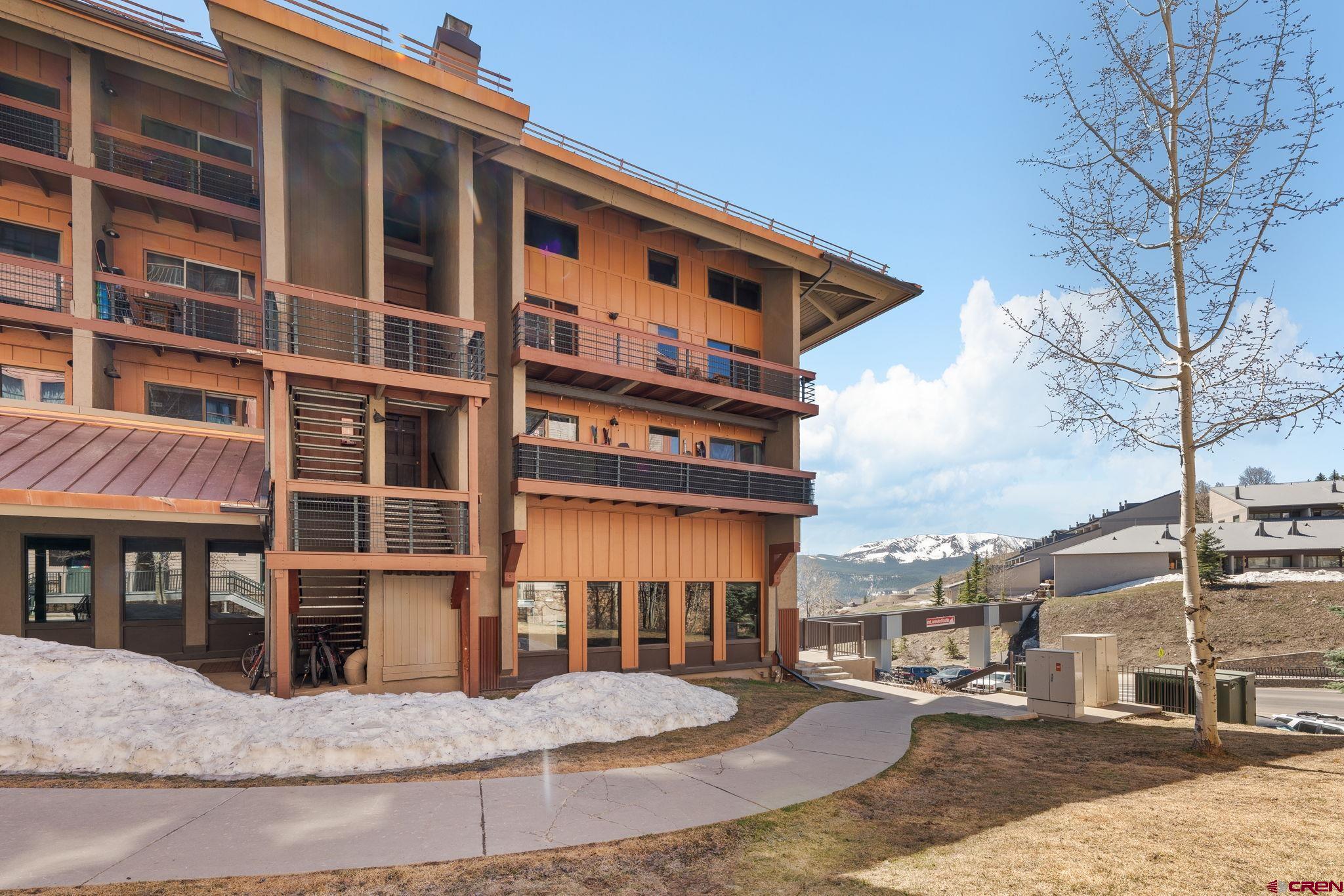 11 Emmons Road, Unit 433 Crested Butte, CO 81225 - Photo 20 of 32 a front view of a house with a yard