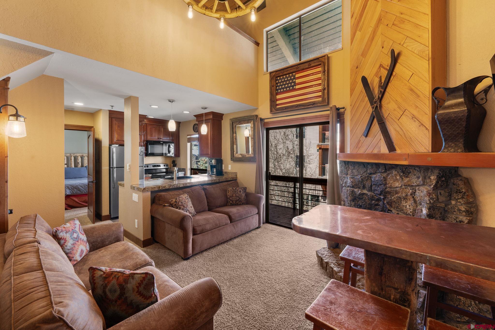 11 Emmons Road, Unit 433 Crested Butte, CO 81225 - Photo 2 of 32 a living room with furniture and a view of kitchen