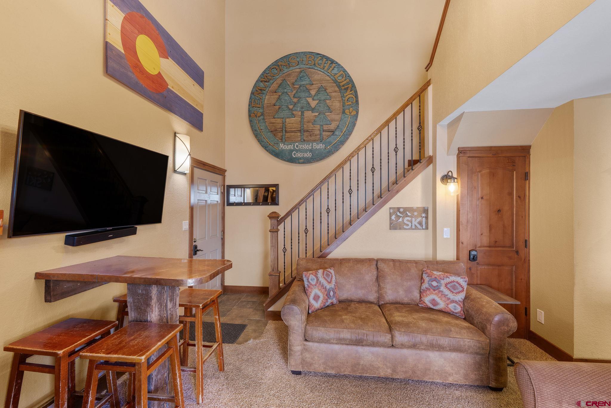 11 Emmons Road, Unit 433 Crested Butte, CO 81225 - Photo 3 of 32 a living room with furniture and a flat screen tv