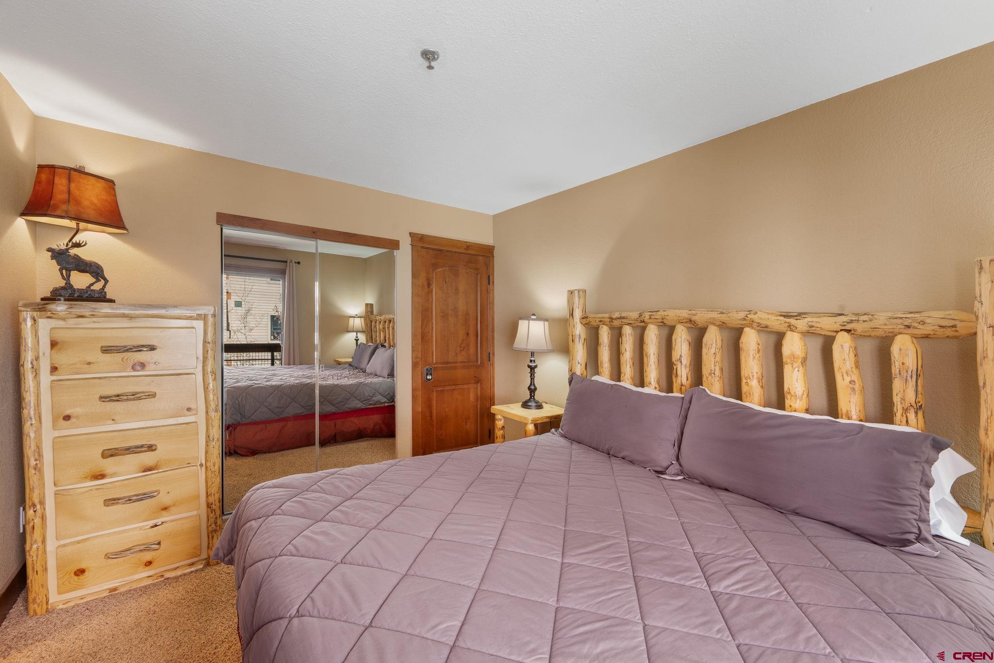 11 Emmons Road, Unit 433 Crested Butte, CO 81225 - Photo 9 of 32 a bedroom with a bed and a cabinets