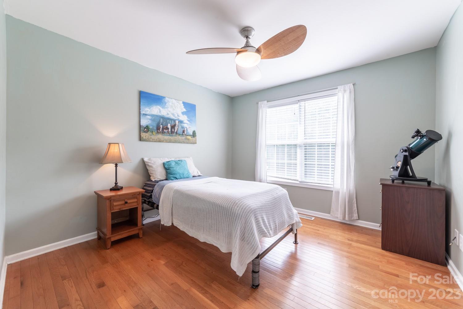 327 Unity Church Road Kings Mountain, NC 28086 - Photo 13 of 30 a bedroom with a bed and a chandelier