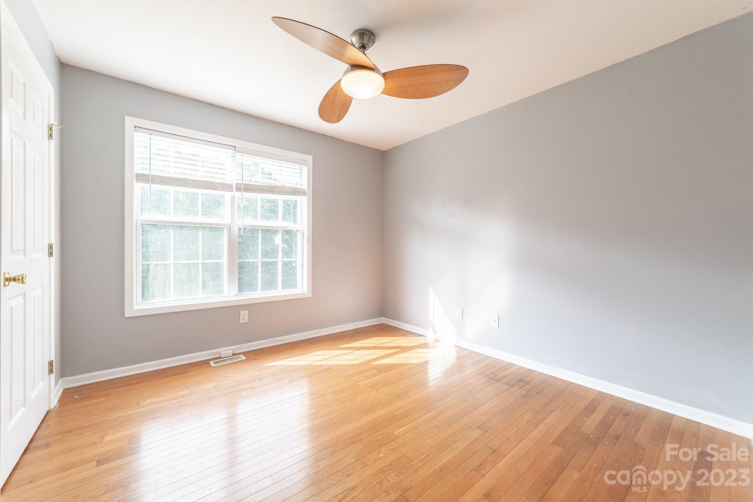 327 Unity Church Road Kings Mountain, NC 28086 - Photo 16 of 30 an empty room with wooden floor and windows