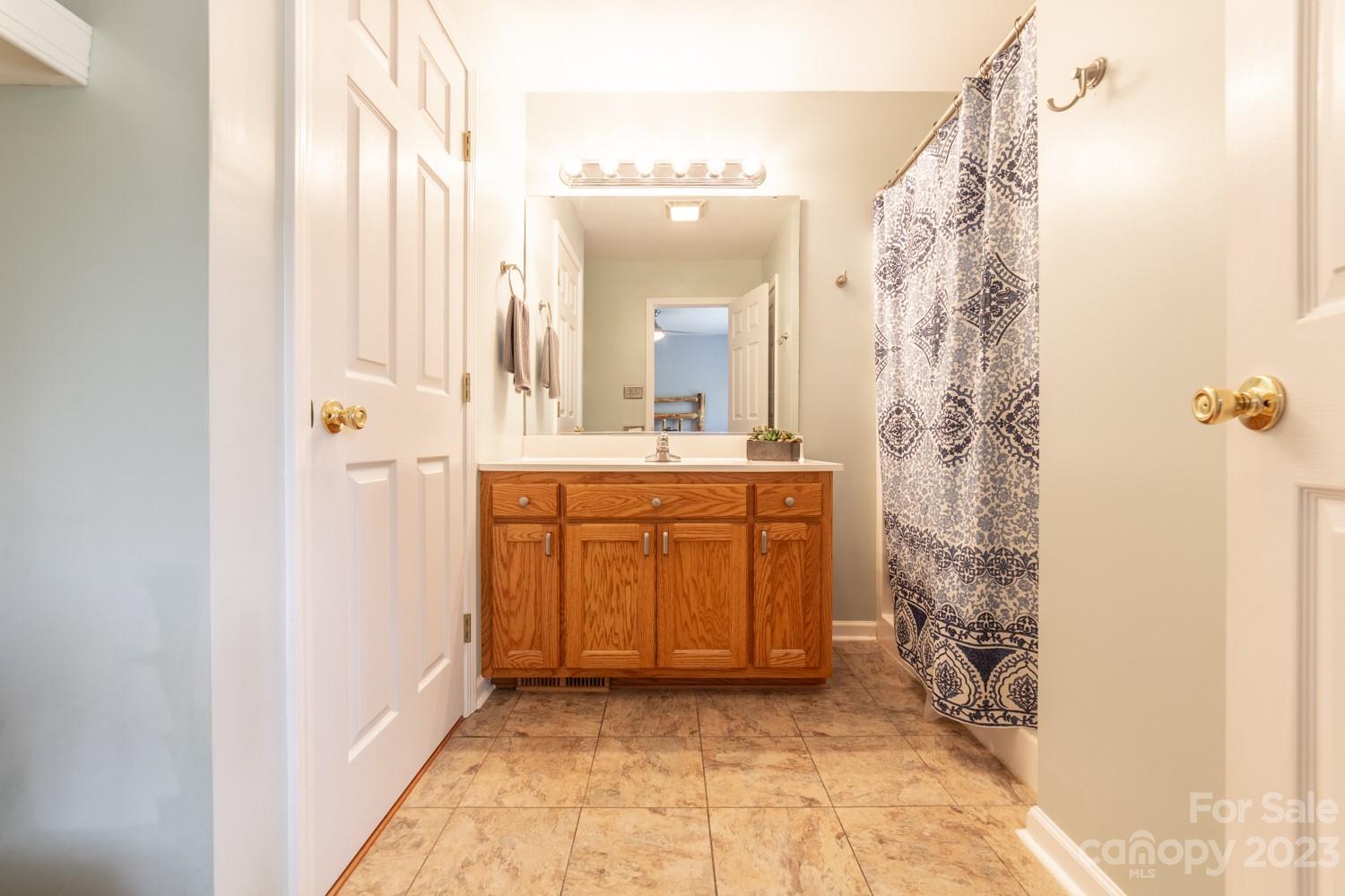 327 Unity Church Road Kings Mountain, NC 28086 - Photo 20 of 30 a bathroom with a sink a mirror and a shower