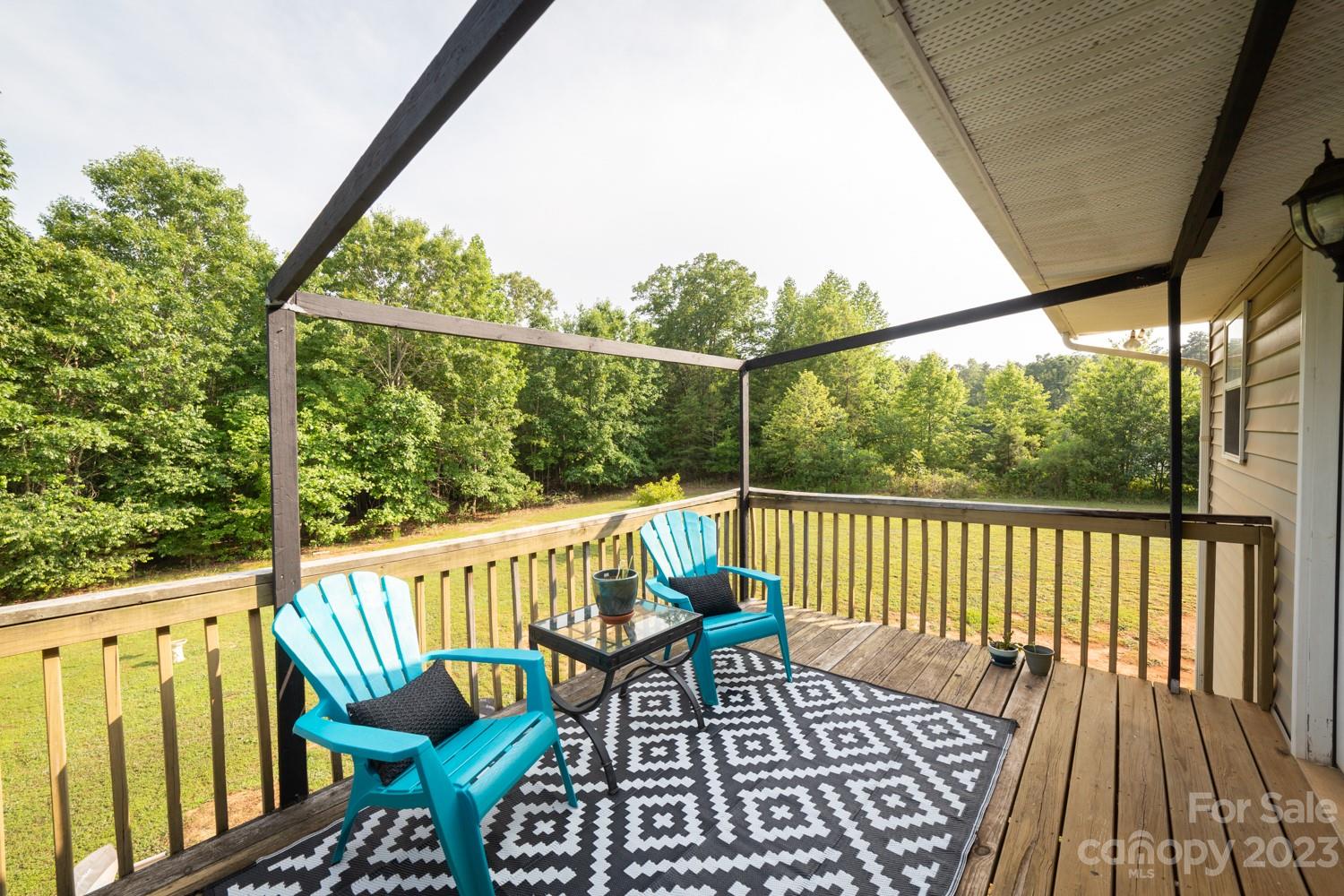 327 Unity Church Road Kings Mountain, NC 28086 - Photo 26 of 30 a view of a chairs on wooden deck