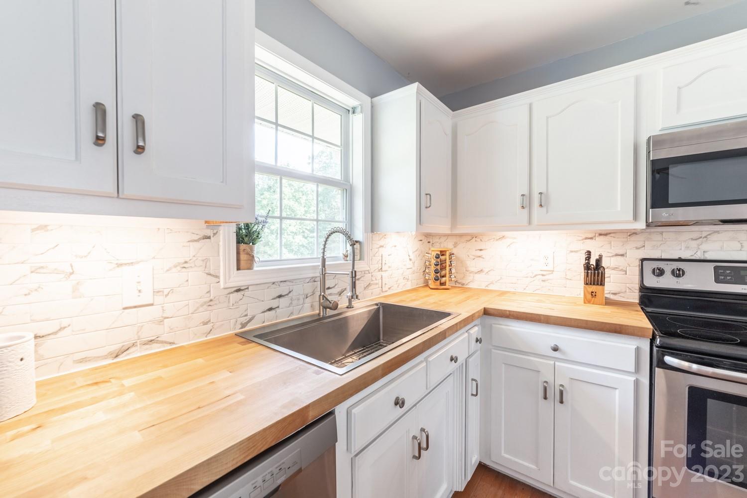 327 Unity Church Road Kings Mountain, NC 28086 - Photo 9 of 30 a kitchen with sink cabinets and window