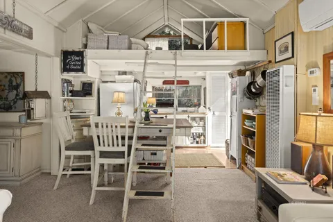 a view of a dining room with furniture and a kitchen