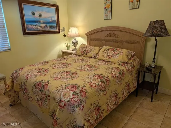 a large bed sitting in a bedroom next to a wall