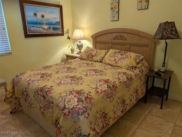 a large bed sitting in a bedroom next to a wall