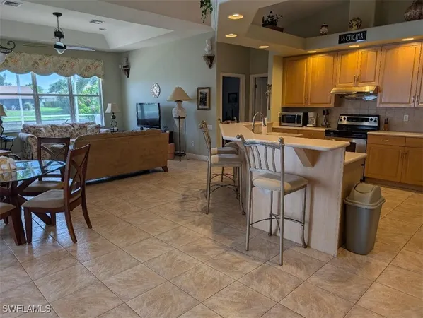 a living room with furniture a floor to ceiling window and a fireplace