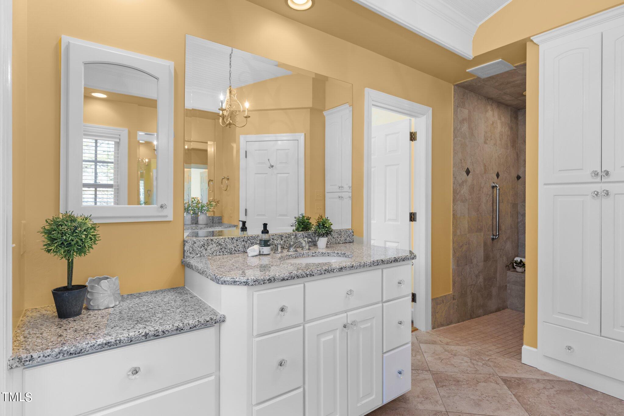 8 Surrey Lane Durham, NC 27707 - Photo 15 of 50 a bathroom with a granite countertop sink a mirror and a