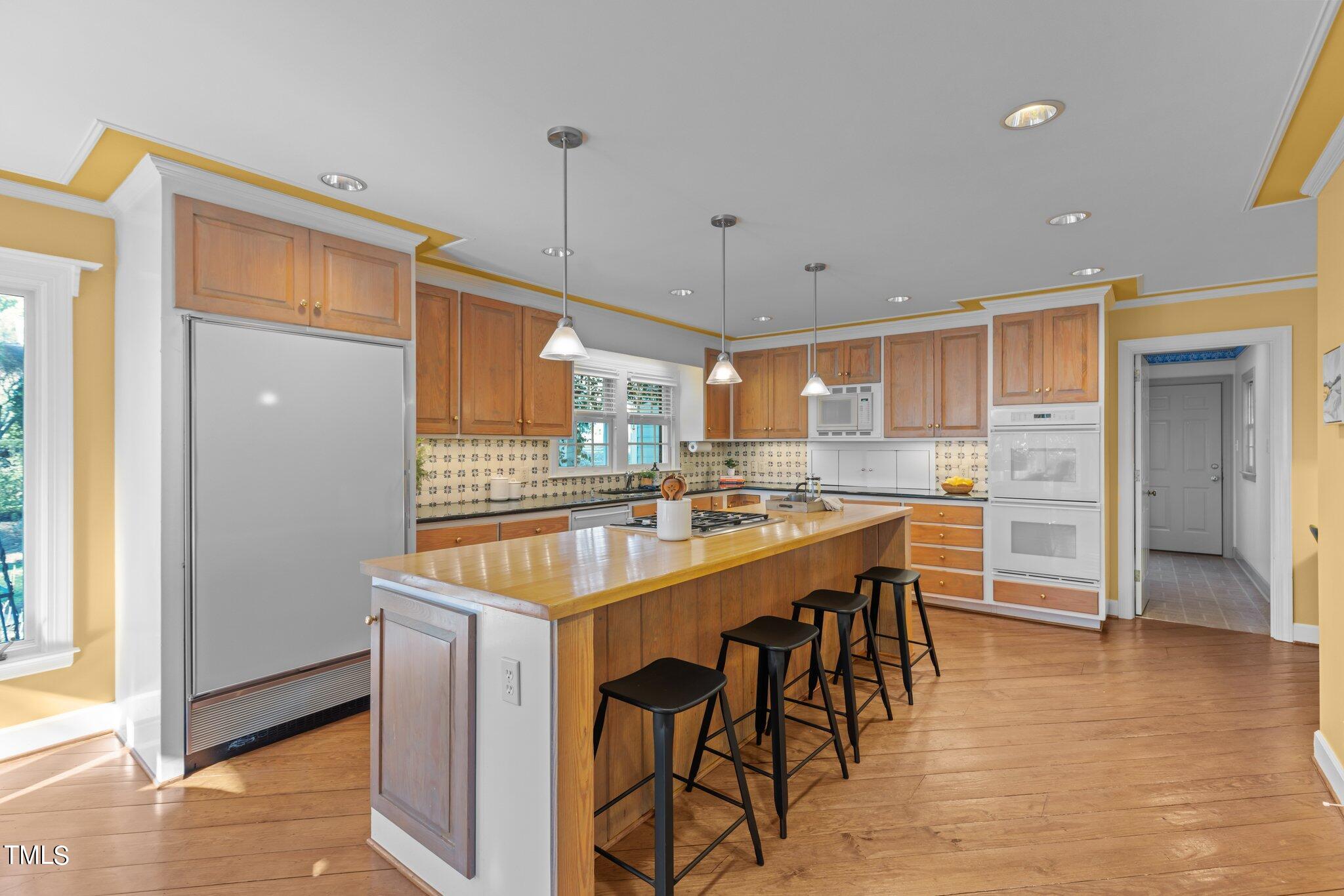 8 Surrey Lane Durham, NC 27707 - Photo 29 of 50 a kitchen with stainless steel appliances granite countertop a refrigerator a sink and a stove