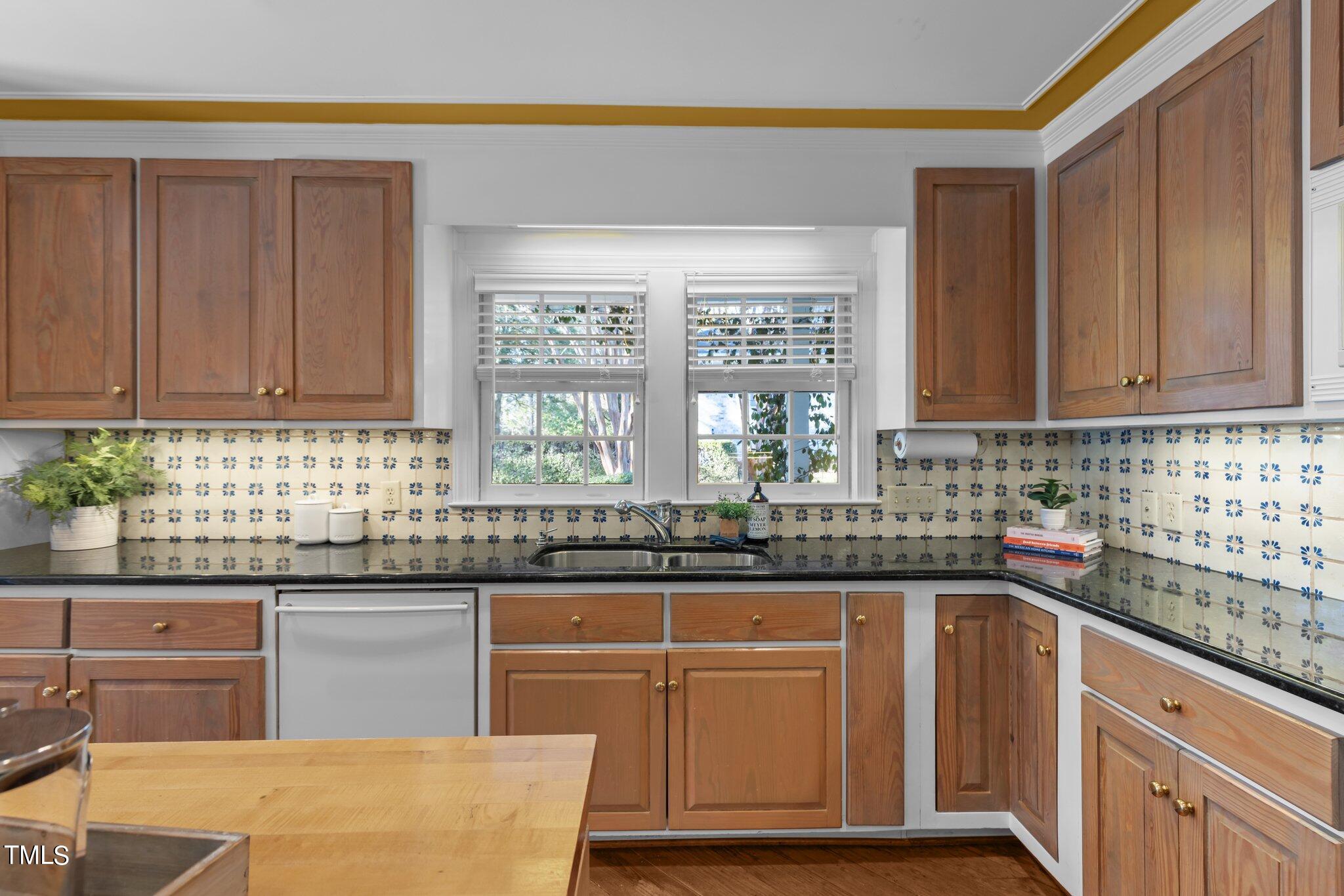 8 Surrey Lane Durham, NC 27707 - Photo 30 of 50 a kitchen with granite countertop a sink and cabinets