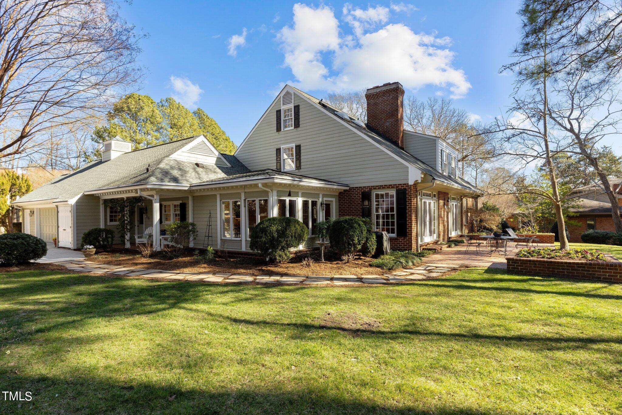 8 Surrey Lane Durham, NC 27707 - Photo 3 of 50 a front view of a house with swimming pool and porch with furniture
