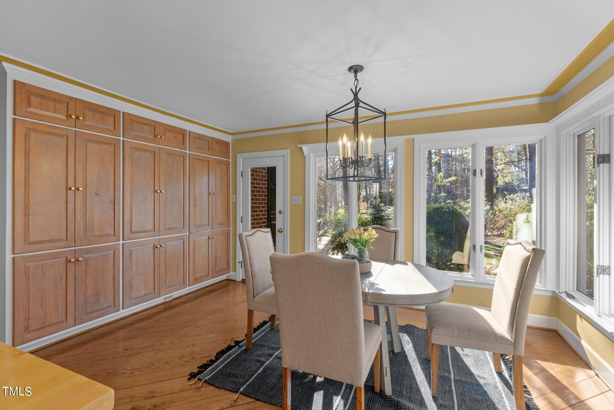 8 Surrey Lane Durham, NC 27707 - Photo 31 of 50 a view of a dining room with furniture wooden floor and chandelier