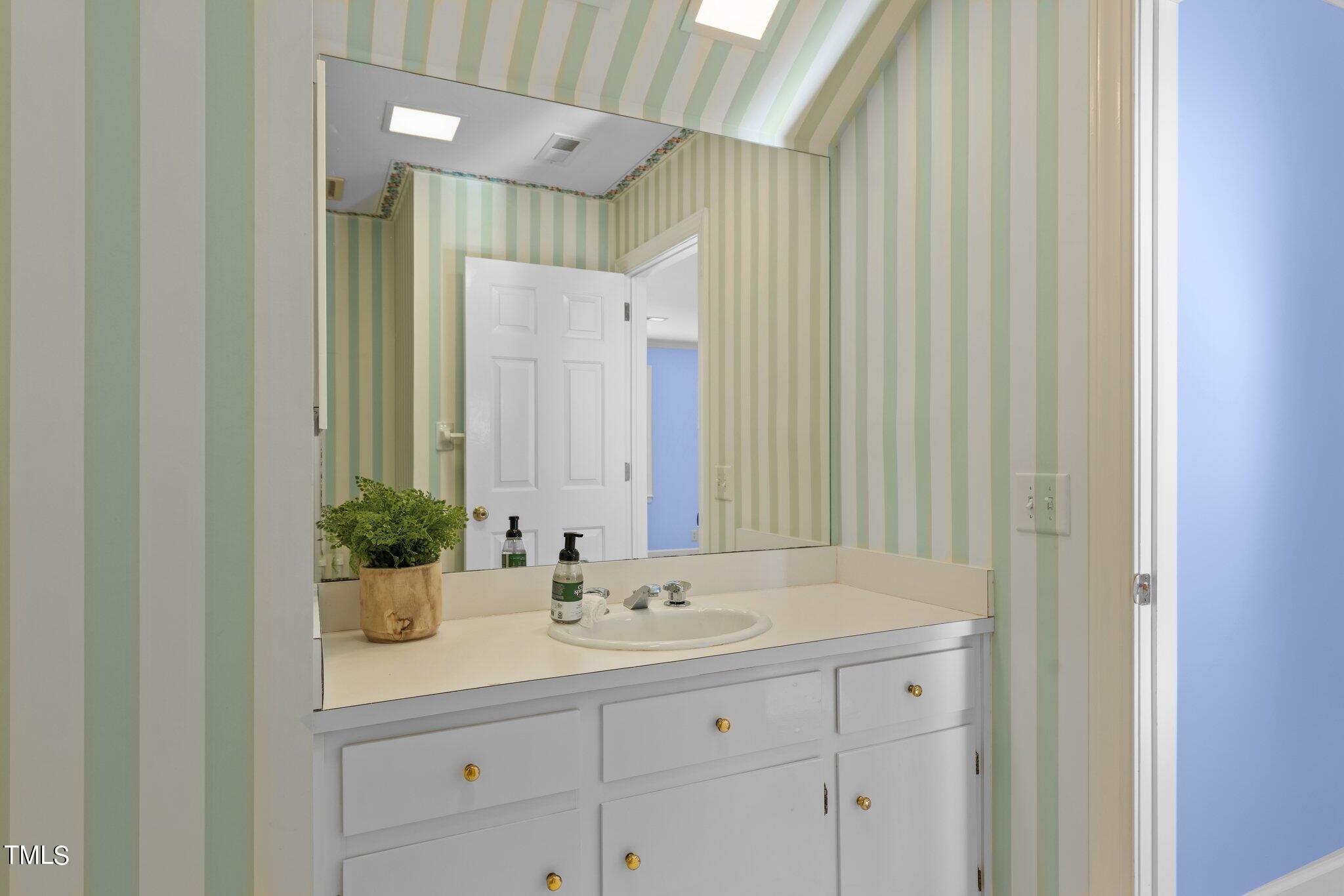 8 Surrey Lane Durham, NC 27707 - Photo 37 of 50 a bathroom with a sink and a mirror