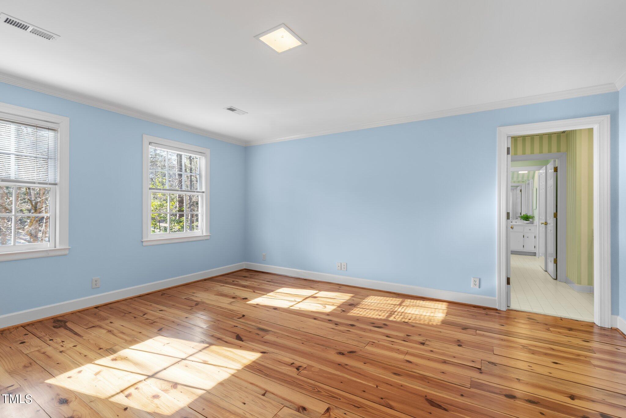 8 Surrey Lane Durham, NC 27707 - Photo 38 of 50 an empty room with wooden floor and windows