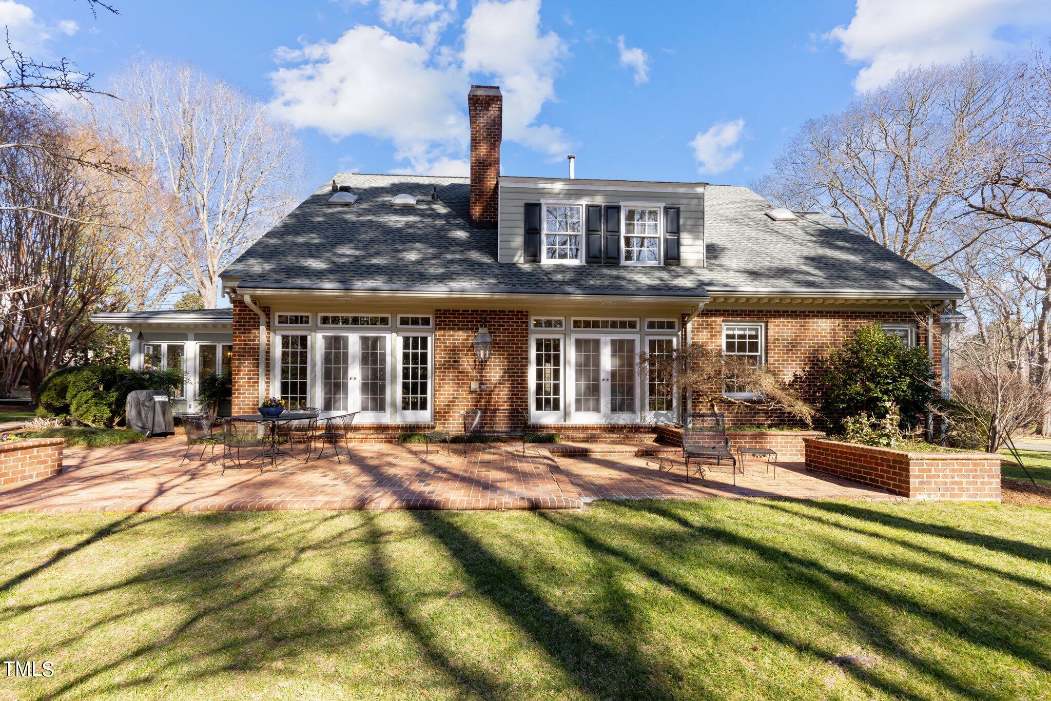 8 Surrey Lane Durham, NC 27707 - Photo 5 of 50 a view of a house with sitting area and garden