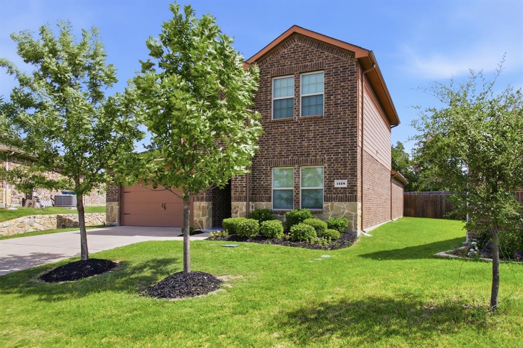 1328 Broaddus Road Forney, TX 75126 - Photo 8 of 31 Brick two-story exterior with stone accents and a two-car garage