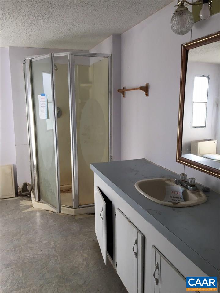 44 Jonquil Road Ruckersville, VA 22968 - Photo 11 of 12 a bathroom with a granite countertop sink and a mirror