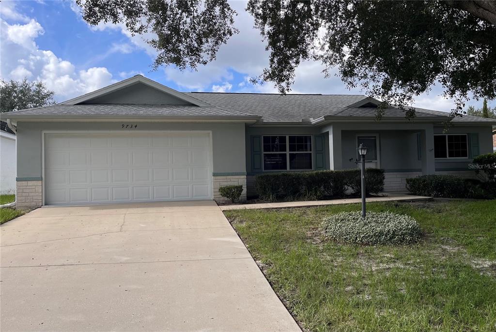 9734 Southwest 96th Street Ocala, FL 34481 - Photo 1 of 1 front view of a house with a yard