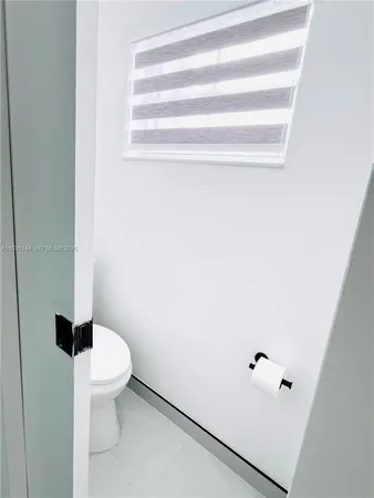 a white toilet sitting next to a bathroom sink