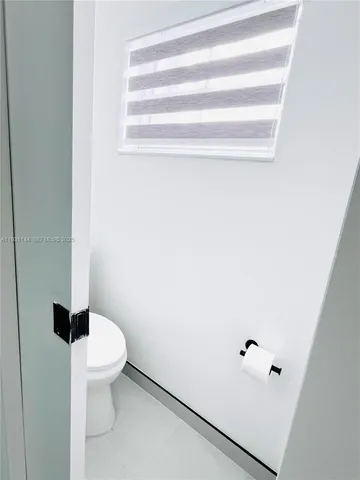 a white toilet sitting next to a bathroom sink