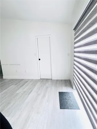a view of wooden floor and windows in a room