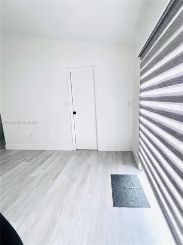 a view of wooden floor and windows in a room