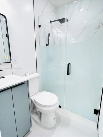 a bathroom with a toilet sink and shower