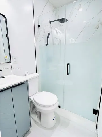 a bathroom with a toilet sink and shower