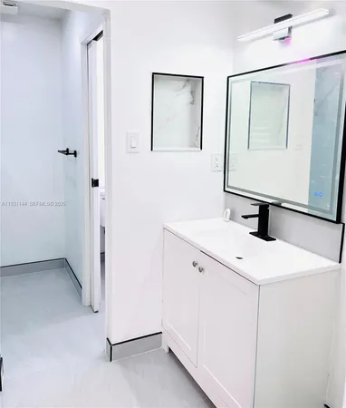 a bathroom with a sink and a mirror