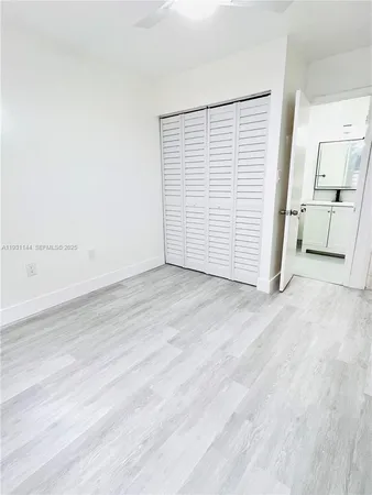 an empty room with wooden floor and white walls