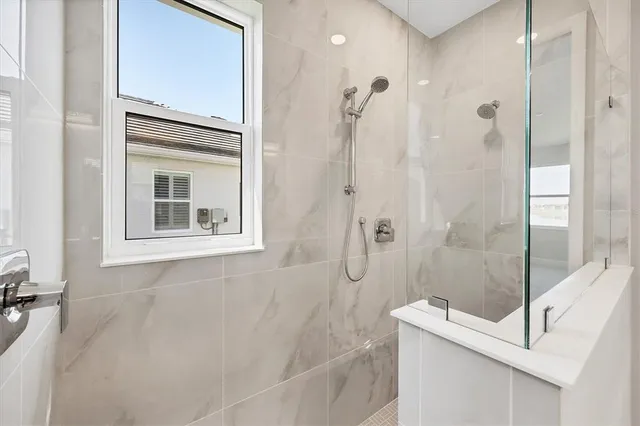 a bathroom with a bathtub shower sink vanity and toilet