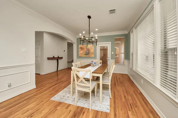 a view of a dining room with furniture and wooden floor