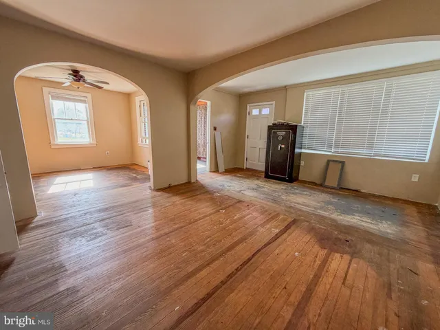 a view of an empty room with closet and a window