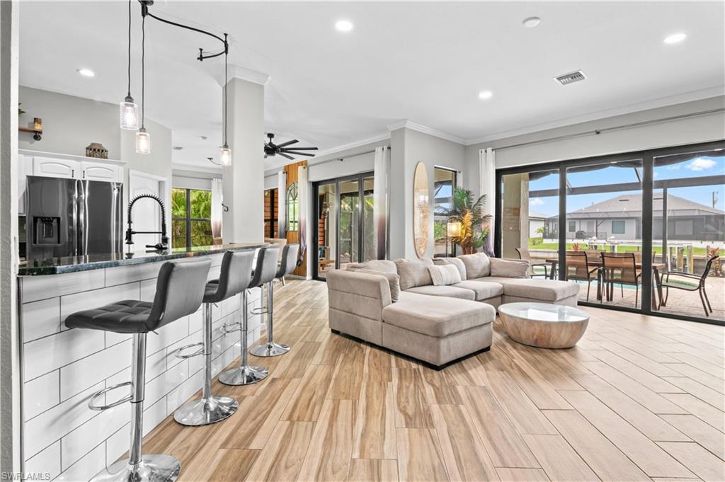 2123 Old Burnt Store Road North Cape Coral, FL 33993 - Photo 13 of 40 a living room with furniture and a large window