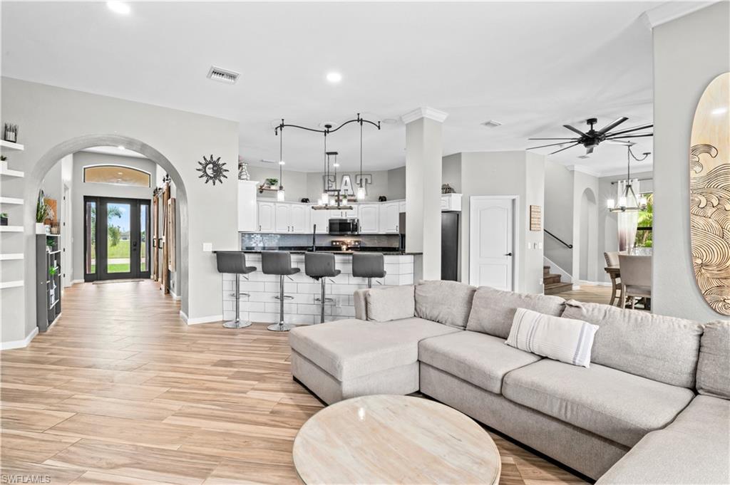 2123 Old Burnt Store Road North Cape Coral, FL 33993 - Photo 14 of 40 a living room with furniture and a wooden floor