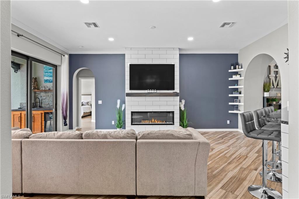 2123 Old Burnt Store Road North Cape Coral, FL 33993 - Photo 17 of 40 a living room with fireplace furniture and a flat screen tv