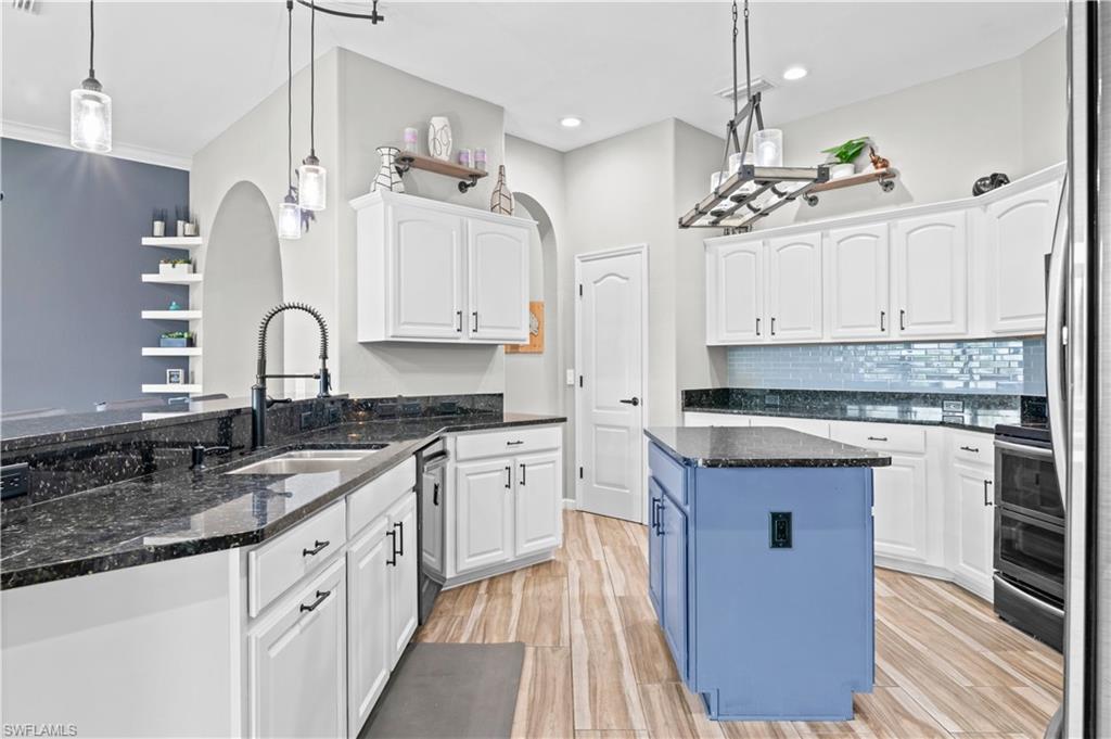 2123 Old Burnt Store Road North Cape Coral, FL 33993 - Photo 21 of 40 a kitchen with granite countertop stainless steel appliances cabinets a sink and a counter top space