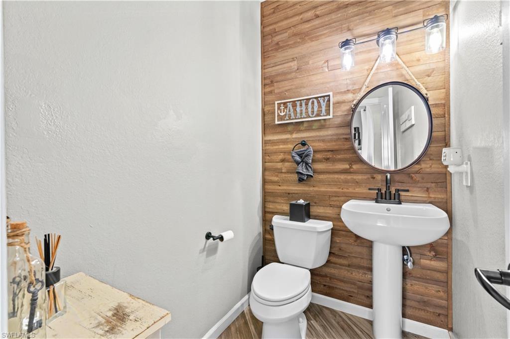 2123 Old Burnt Store Road North Cape Coral, FL 33993 - Photo 22 of 40 a bathroom with a toilet sink and mirror