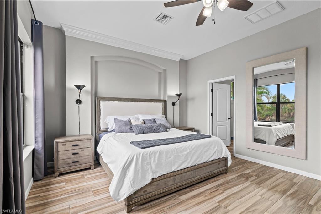 2123 Old Burnt Store Road North Cape Coral, FL 33993 - Photo 24 of 40 a bedroom with a bed and a large window