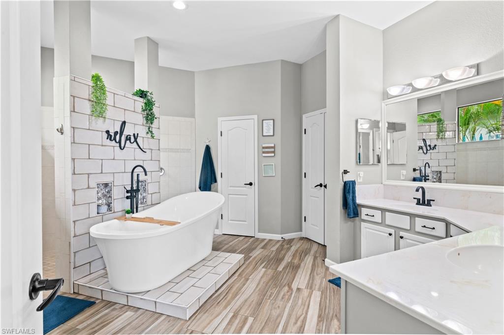 2123 Old Burnt Store Road North Cape Coral, FL 33993 - Photo 25 of 40 a white bath tub sitting next to a white toilet